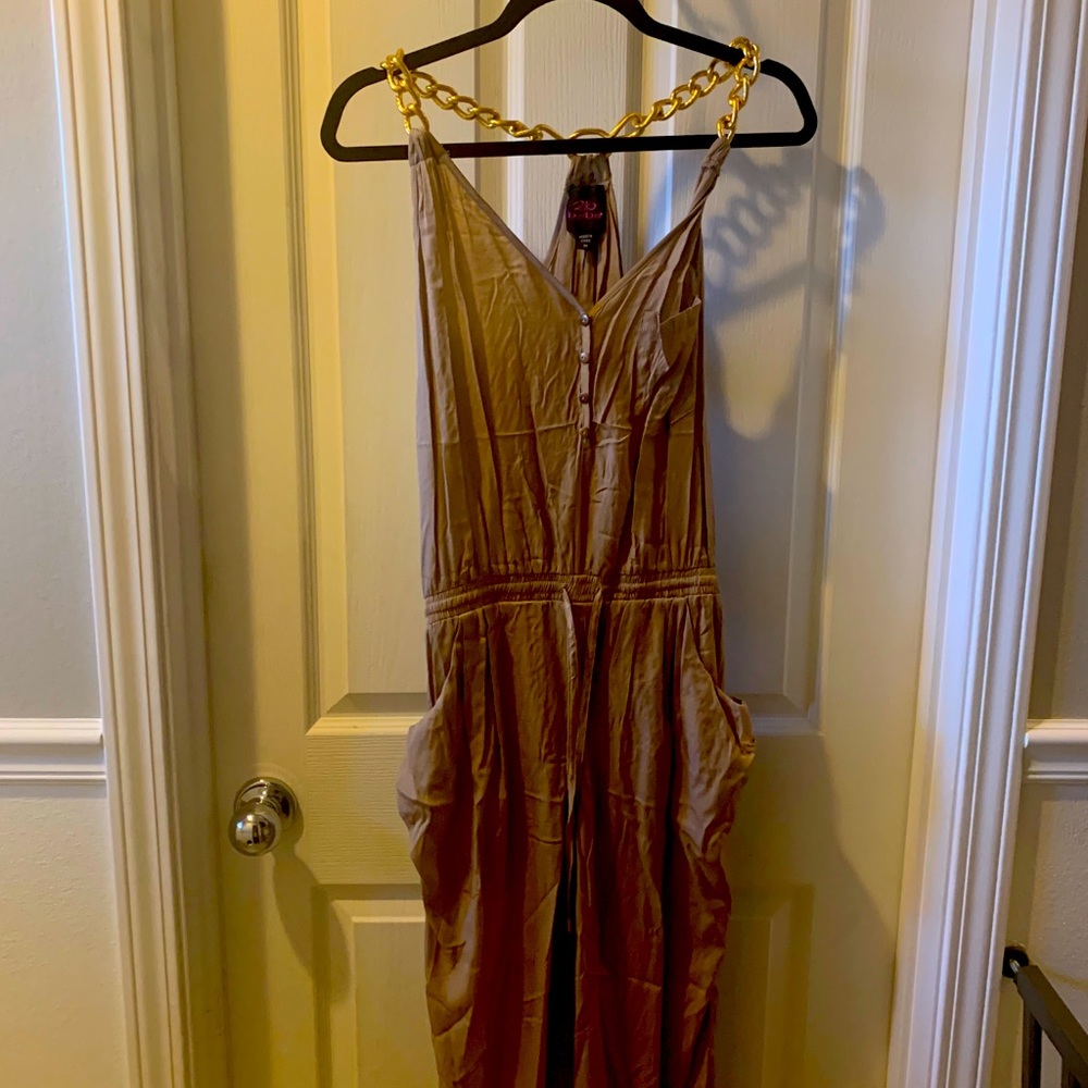 Tan satin jumpsuit with gold chain shoulder straps